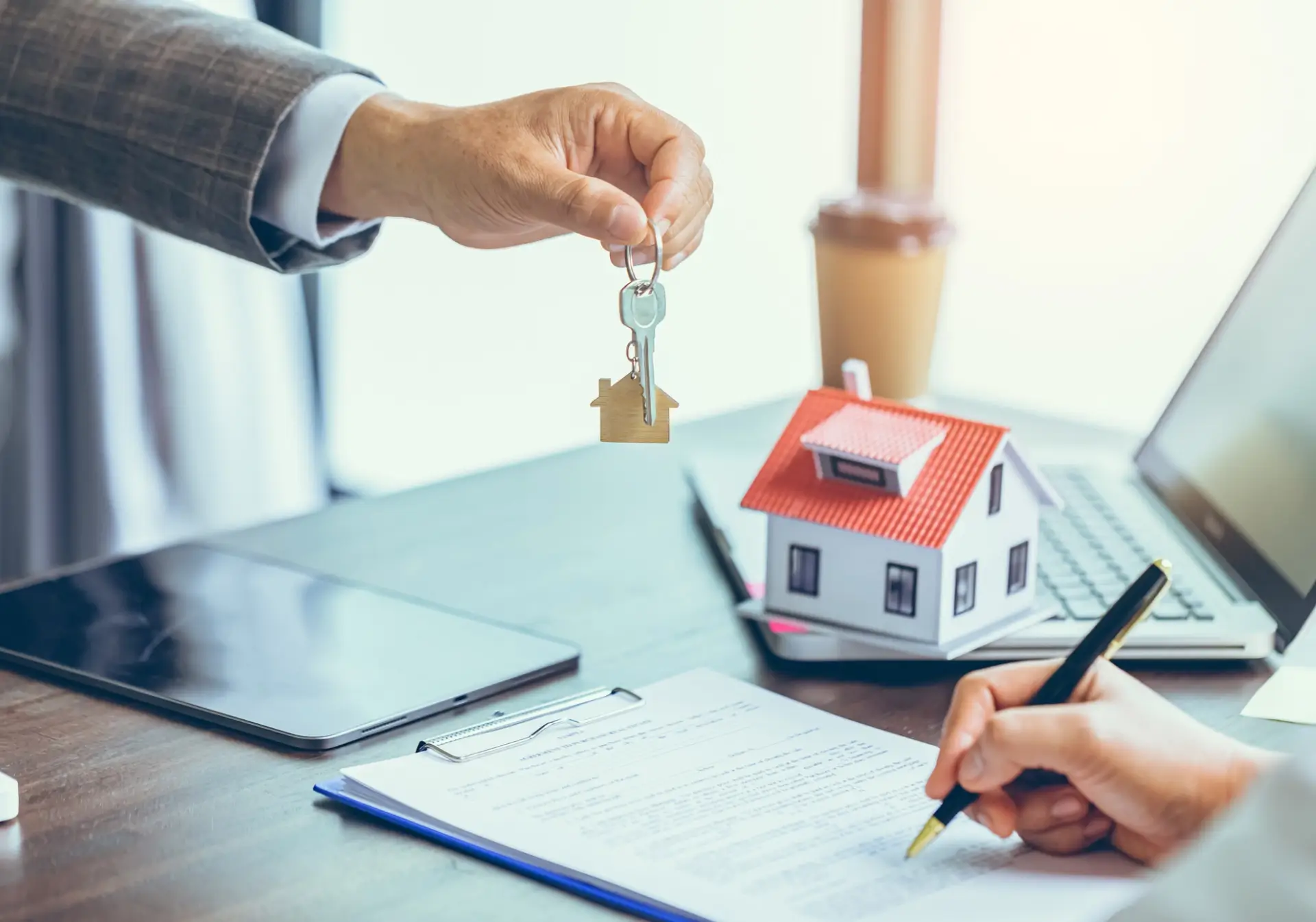 Handing house keys over signed contract.
